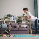 a woman and a child playing in a living room